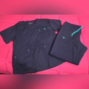 Women’s Med Couture navy blue scrubs, size Med top and Med Petite pants.